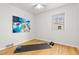 Neutral bedroom with bright art has space for a yoga mat and weights at 3230 Vance St, Wheat Ridge, CO 80033
