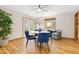 Bright dining room with hardwood floors features a round table and modern blue chairs at 3230 Vance St, Wheat Ridge, CO 80033