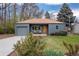Charming blue single-story home featuring a manicured lawn, gray garage, and cozy front porch with seating at 3230 Vance St, Wheat Ridge, CO 80033