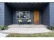 Cozy porch with seating, vibrant plants, and a stylish wood front door with the house number displayed at 3230 Vance St, Wheat Ridge, CO 80033