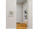 Bright hallway with hardwood floors, a charming built-in shelf, and an open doorway to a stylishly furnished room at 3230 Vance St, Wheat Ridge, CO 80033