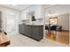 Well-lit kitchen boasts gray cabinets, white subway tile backsplash, and a butcher block countertop at 3230 Vance St, Wheat Ridge, CO 80033