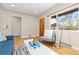 Cozy living room featuring hardwood floors, a bright window, and stylish decor, blending comfort with modern design at 3230 Vance St, Wheat Ridge, CO 80033