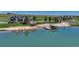 Aerial view of a lakeside property, featuring a private dock, gazebo, kayaks, and manicured grounds at 6234 Nautique Cir, Larkspur, CO 80118