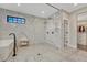 Spa-like bathroom featuring marble walls, a glass-enclosed shower, and a soaking tub at 6234 Nautique Cir, Larkspur, CO 80118