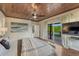 Bedroom featuring hardwood floors, a ceiling fan, and access to a private deck at 6234 Nautique Cir, Larkspur, CO 80118