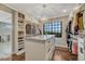 Spacious walk-in closet with custom shelving, drawers, and natural light at 6234 Nautique Cir, Larkspur, CO 80118