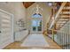 Grand foyer with chandelier, staircase, and scenic outdoor views through glass doors at 6234 Nautique Cir, Larkspur, CO 80118