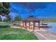 Charming gazebo with a fire pit by the water, perfect for lakeside relaxation and social gatherings at 6234 Nautique Cir, Larkspur, CO 80118