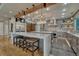 Open kitchen with marble countertops, stainless steel appliances, designer lighting and dark wood accents and hardwood floors at 6234 Nautique Cir, Larkspur, CO 80118