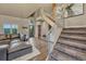Open living room with fireplace, modern staircase, and hardwood floors at 6234 Nautique Cir, Larkspur, CO 80118