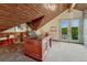 Home office with wood ceilings, built-in bookshelves, and balcony access at 6234 Nautique Cir, Larkspur, CO 80118