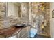 Unique powder room with stone walls, vessel sink, and decorative lighting at 6234 Nautique Cir, Larkspur, CO 80118
