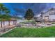 Expansive waterfront property with stone landscaping and a gazebo, offering a serene and picturesque setting at 6234 Nautique Cir, Larkspur, CO 80118