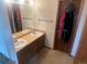 Bathroom with double vanity and separated by a door from another room at 14828 E Pacific Pl, Aurora, CO 80014