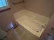 Bathroom has a bathtub in a light tile room at 14828 E Pacific Pl, Aurora, CO 80014
