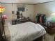 Bedroom with large bed, wood floors, side table and dresser at 14828 E Pacific Pl, Aurora, CO 80014
