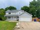 Charming two-story home with attached garage, solar panels, well maintained lawn, and front porch swing at 14828 E Pacific Pl, Aurora, CO 80014