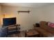 Cozy living room with sofa, TV, and minimal decoration at 14828 E Pacific Pl, Aurora, CO 80014