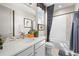 Clean bathroom with a bathtub, shower, and double vanity at 6020 N Orleans St, Aurora, CO 80019