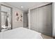 Bright bedroom with double doors leading to a full bathroom and walk in closet at 6020 N Orleans St, Aurora, CO 80019