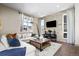 Spacious living room featuring a sectional sofa and wood-look flooring at 6020 N Orleans St, Aurora, CO 80019