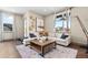Cozy living room with sectional sofa and large windows at 6020 N Orleans St, Aurora, CO 80019