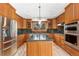 Modern kitchen featuring stainless steel appliances, granite countertops, and wooden cabinets at 8916 Prairie Knoll Dr, Longmont, CO 80503