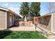 Backyard view featuring a patio area with covered furniture, lush green grass, and privacy at 2900 Clermont St, Denver, CO 80207