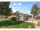 Expansive backyard showcases a well-manicured lawn, mature trees, and a charming patio area at 2900 Clermont St, Denver, CO 80207