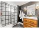 Stylish bathroom featuring a modern glass shower, sleek vanity, and black accent wall for a contemporary design at 2900 Clermont St, Denver, CO 80207