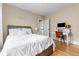 Comfortable bedroom with hardwood floors, a cozy bed, a desk, and a chair, perfect for relaxation or study at 2900 Clermont St, Denver, CO 80207