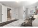 Bright bedroom with a modern desk and view to an ensuite bath with barn doors at 2900 Clermont St, Denver, CO 80207