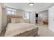Cozy bedroom featuring a textured wood headboard, plush bedding, and an open doorway leading to a living area with a fireplace at 2900 Clermont St, Denver, CO 80207