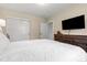 Bedroom with a large closet, neutral walls, a mounted TV, and dresser at 2900 Clermont St, Denver, CO 80207