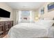 Bedroom featuring hardwood floors, natural light from a window, comfortable bed, and built-in dresser at 2900 Clermont St, Denver, CO 80207