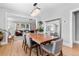 Open-concept dining room featuring a wood table, gray chairs, modern chandelier and large mirror for extra light at 2900 Clermont St, Denver, CO 80207
