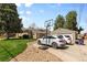 Charming home featuring a driveway, basketball hoop, and lush green lawn, perfect for outdoor activities at 2900 Clermont St, Denver, CO 80207