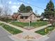 Inviting home featuring a well-manicured lawn and charming curb appeal on a corner lot at 2900 Clermont St, Denver, CO 80207