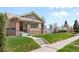 Beautifully landscaped front yard with a charming home and inviting entryway at 2900 Clermont St, Denver, CO 80207