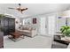 Comfortable Gathering room featuring a neutral sofa, wood-bladed ceiling fan, and access to the patio at 2900 Clermont St, Denver, CO 80207
