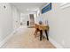 Inviting hallway with a desk, artwork, and staircase creating a welcoming transition between spaces at 2900 Clermont St, Denver, CO 80207