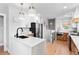 Modern kitchen features white and wood cabinets, stainless steel appliances, and quartz countertops at 2900 Clermont St, Denver, CO 80207
