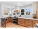 Bright kitchen featuring light wood cabinets, stainless steel appliances, and stylish countertops at 2900 Clermont St, Denver, CO 80207
