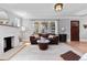 Bright living room boasts a stone fireplace, a brown leather sofa, hardwood floors and light gray colored walls at 2900 Clermont St, Denver, CO 80207