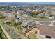 Aerial view shows a home's fenced backyard, covered patio and a shed in a verdant neighborhood at 17522 E Dewberry Dr, Parker, CO 80134