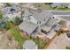 Beautiful gray two-story home boasts landscaped yard, covered patio, and outdoor seating area at 17522 E Dewberry Dr, Parker, CO 80134