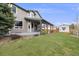 A nice backyard featuring an outdoor living area with a ceiling fan and a storage shed at 17522 E Dewberry Dr, Parker, CO 80134