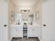 This is a well-lit bathroom with double vanity, decor lighting and neutral decor at 17522 E Dewberry Dr, Parker, CO 80134