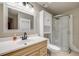 Bathroom featuring a vanity sink, vanity mirror, and a corner shower stall at 17522 E Dewberry Dr, Parker, CO 80134